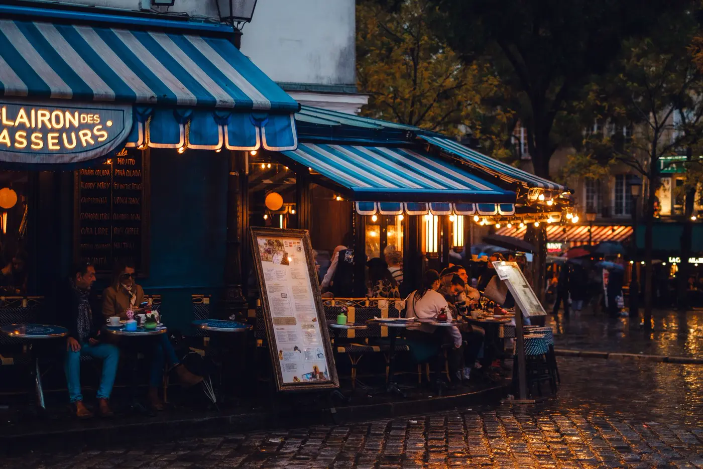 A café terrace on a rainy evening.