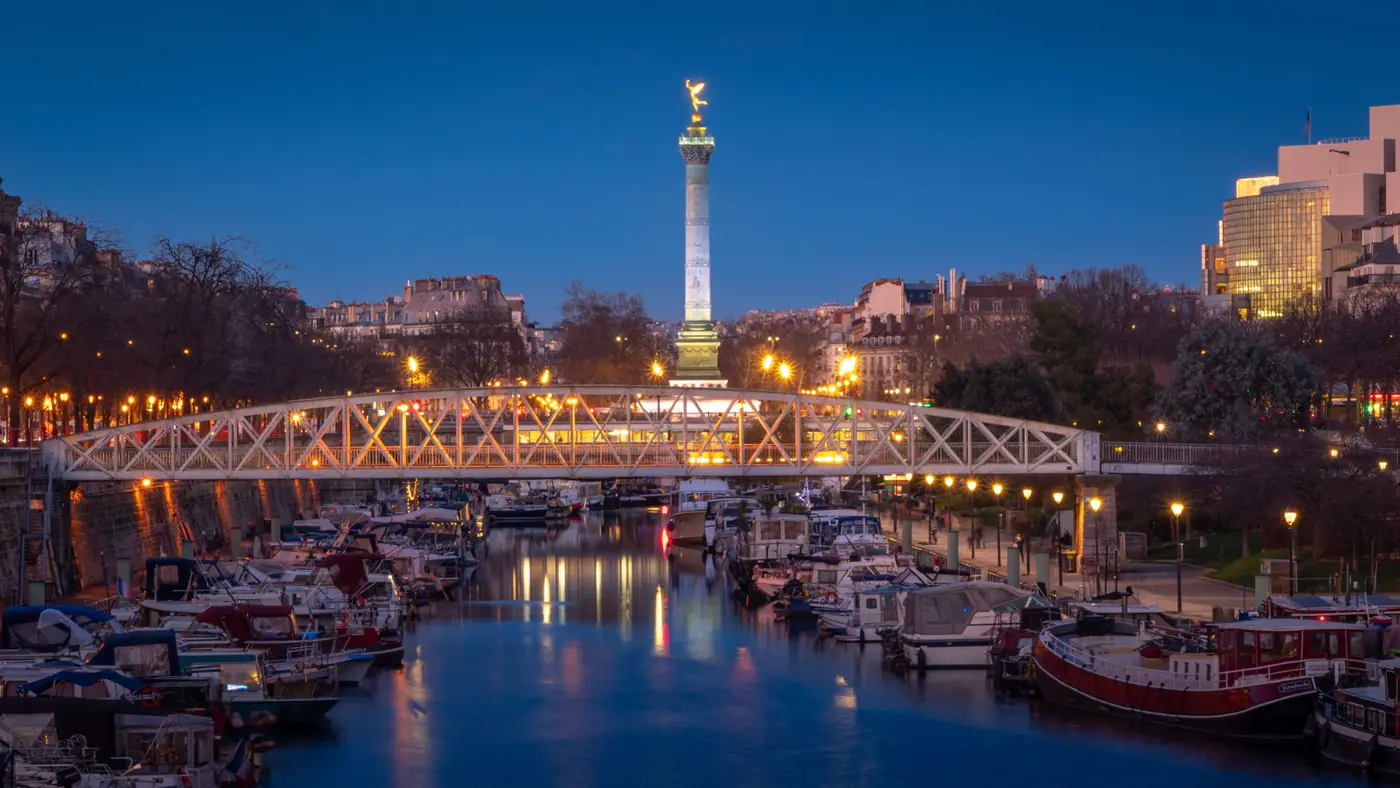 Boats below Place de la Bastille at dusk.